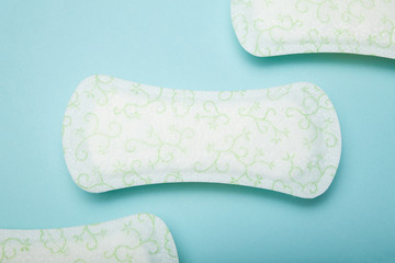 Menstrual pad on pastel blue background. Concept.