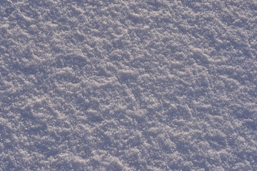 Natural background - ice surface of snow illuminated by the rays of the evening sun. The sun's rays bouncing off the gleaming crystals loose ice..