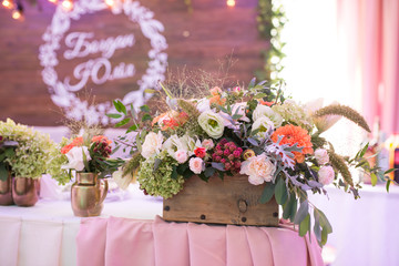 Rustic flower arrangement at a wedding banquet. Table set for an event party or wedding reception.