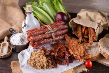 Chinese sausage and Pounded pork jerky for cook on a wooden background