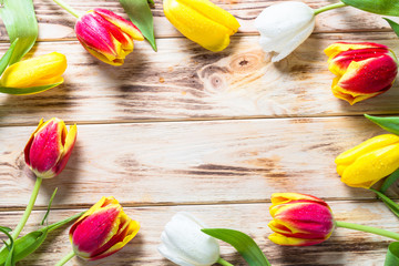 Tulips on wooden table. Flower background.