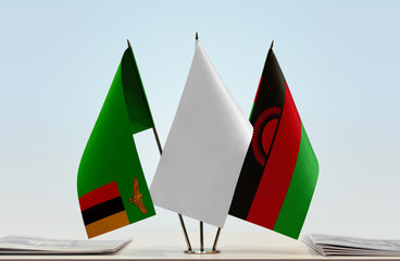 Flags of Zambia and Malawi with a white flag in the middle