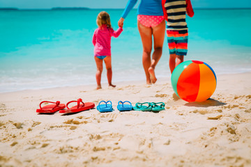 mother with son and daughter walking at beach