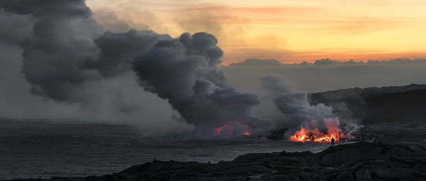 "Pele's Midwife"  A lone hiker takes in the view of lava pouring into the ocean on Hawaii's Big Island.