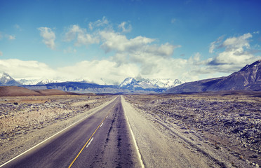 Road to El Chalten village with Fitz Roy Mountain range in background, color toned picture, Argentina.