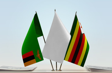 Flags of Zambia and Zimbabwe with a white flag in the middle