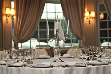 Fototapeta na wymiar Glass dishes on a table on a white tablecloth
