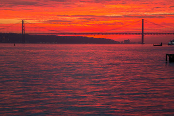 Lisbon (Portugal) - View of river Tejo in the sunset and 25th April Bridge