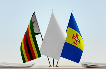 Flags of Zimbabwe and Madeira with a white flag in the middle