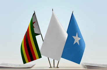 Flags of Zimbabwe and Somalia with a white flag in the middle