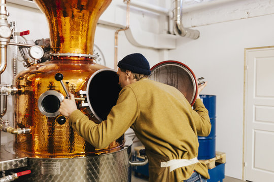 Worker at gin distillery in Sweden - Powered by Adobe