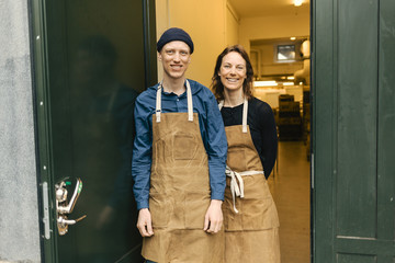 Smiling couple standing outside gin distillery
