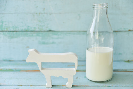 milk bottle, glass of milk, a figure of a cow the concept of rural food, fresh food