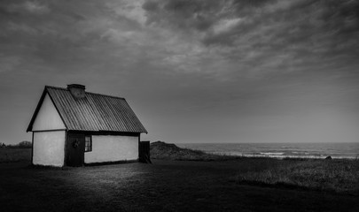 White stone house on the coast on a cloudy day