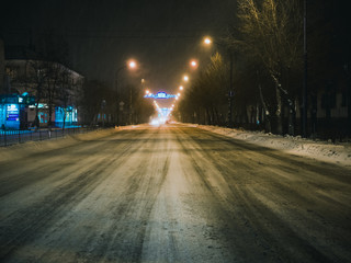 highway road without cars on a winter snowy night