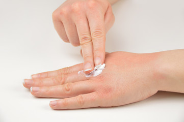 hand and putting moisturizer