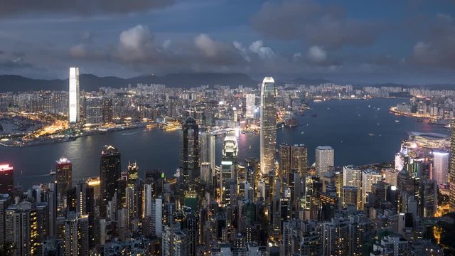 an evening panning right timelapse of victoria harbour and hong kong island from the peak in hong kong, china