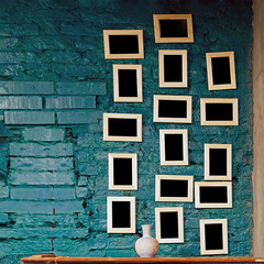 lots of picture frames hanging on the wall