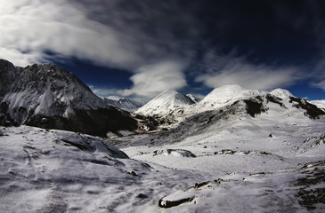 Obraz premium Winter night mountain frozen river valley with ranges of snow peaks under moon light Altai Mountains Siberia Russia