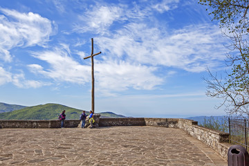 Cross on the cliff of Vern, at an altitude of 1128 meters. The Sanctuary of La Verne. Italy © aphonua