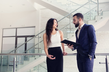 Fototapeta premium Two business colleagues talk about work outside office.