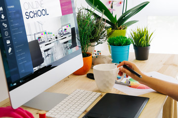 desk with computer and pen tablet online school