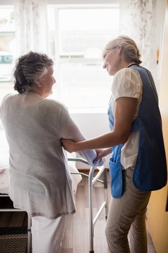 Nurse helping senior woman to walk