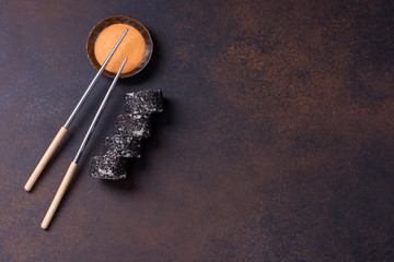Obraz na płótnie Canvas Sushi roll with salmon and black sesame