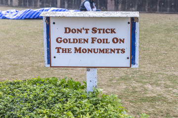 Text: Don's Stick Golden Foil On The Monuments, information sign for visitors in Sarnath, Varanasi,...