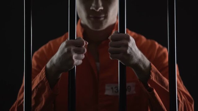 Aggressive inmate grasping prison bars, unfairly judged, court sentence appeal