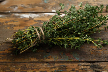Bunch of fresh thyme on wooden background