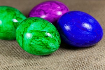 Colored Easter eggs on a brown textile background