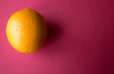 ripe orange on a red background