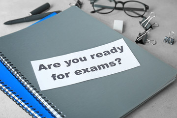 Paper with question "Are you ready for exams?" on notebooks