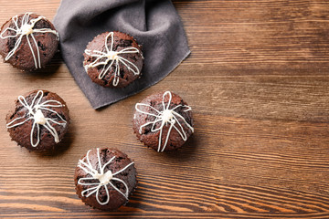Tasty chocolate cupcakes on wooden background