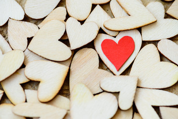 Vintage style of 2 red hearts with wooden hearts on a wooden background. Happy Valentine's Day concept.