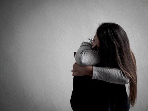 Depressed broken hearted woman sitting alone in dark room at home. Lonly , sad, LOVE and  valentines day concept.