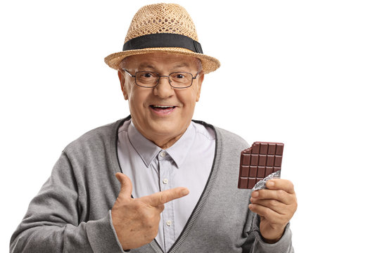 Mature man holding a chocolate bar and pointing