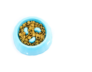 Pet bowl with dry food isolated on white.  Concept product for pet