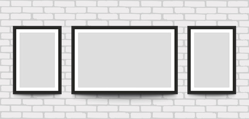 Blank picture frame for photographs on the brick wall.