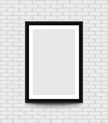 Blank picture frame for photographs on the brick wall.