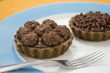 Fudge balls and chocolate pies over plate