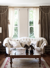 classic living room interior with brown carpet windows and white classic sofa. wood concept.