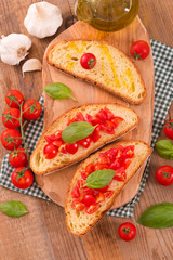Bruschetta bread with basil and chopped tomatoes. 