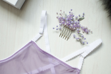 Sexy violet  lingerie on the white wooden background. Fasion woman underwear and accessories