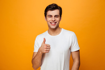 Smiling man in t-shirt showing thumb up