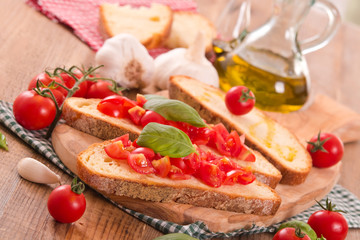 Bruschetta bread with basil and chopped tomatoes. 