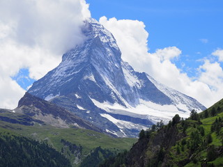 Naklejka na ściany i meble Matterhorn mount in clouds and alpine mountains range landscape in swiss Alps seen from Gornergrat in SWITZERLAND
