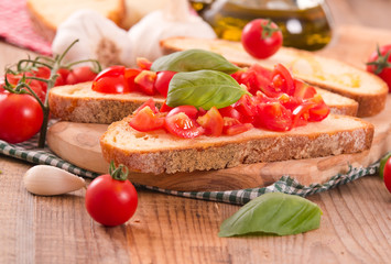 Bruschetta bread with basil and chopped tomatoes. 