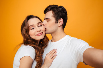 Young lovely couple posing together with klosed eyes